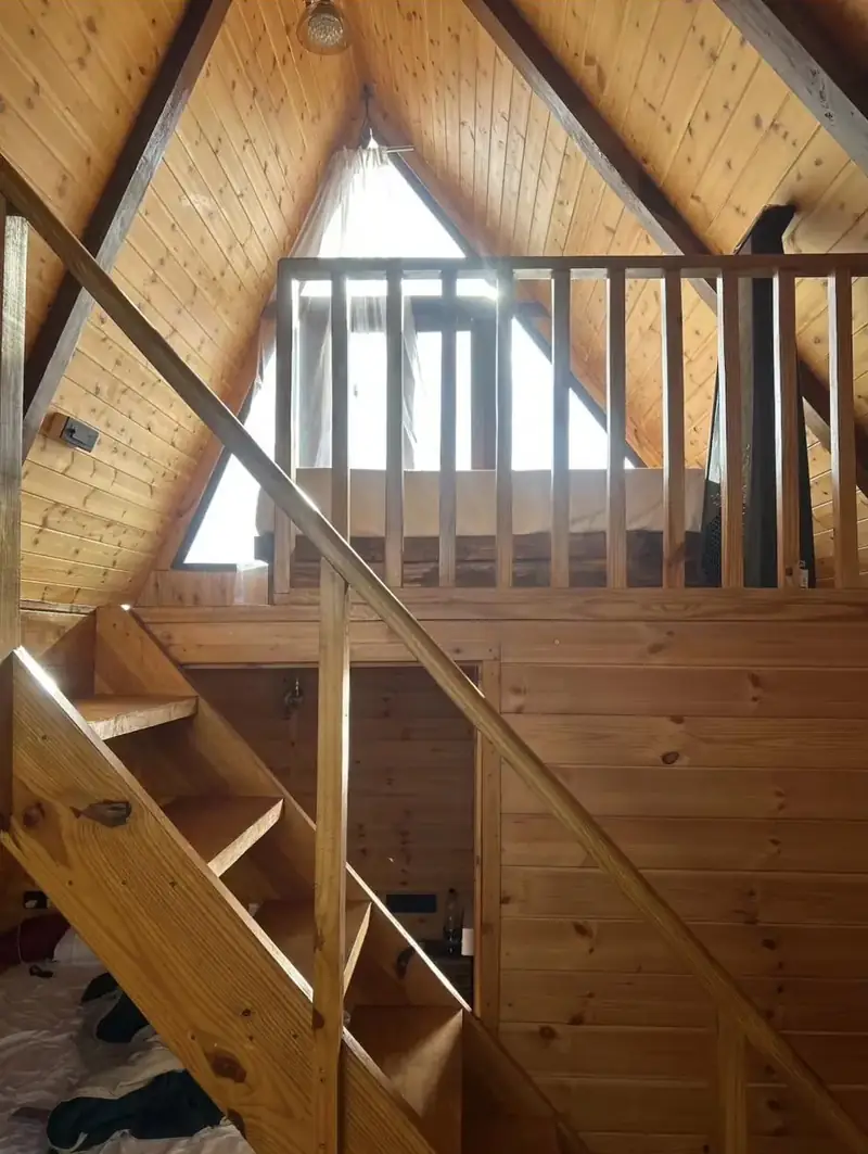 Pine staircase up to the loft bed