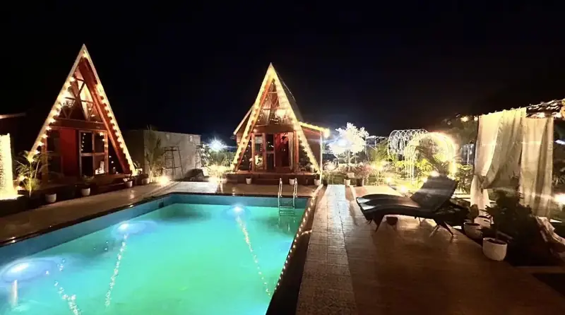 The pool glowing turquoise at night